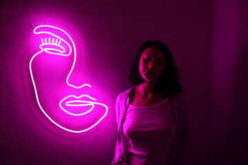 A beautiful girl with pink neon sign face. Trendy style. Beauty salon. Neon sign. Custom neon....