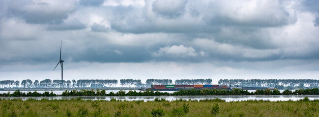 Inland shipping container with dramatic clouds in the Netherlands