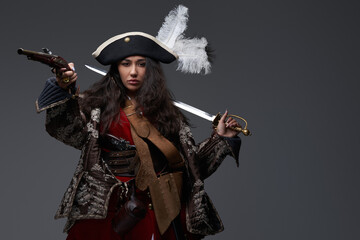 Attractive woman corsair with saber and flintlock