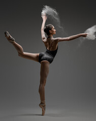 Artistic ballerina wearing black activewar and dancing