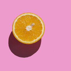 Orange slice isolated on pink background. Fresh juicy fruit