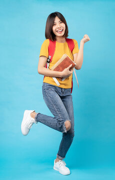 Portrait of young female student, isolated on blue background