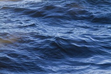 Waves and ripples on river water surface