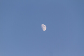 Moon in blue summer sky