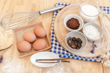 Top View Baking Preparation on wooden Table,Baking ingredients. Bowl, eggs and flour, rolling pin and eggshells on wooden board,Baking concept
