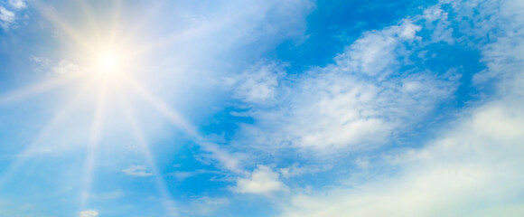 Naklejka na ściany i meble blue sky , sun and beautiful white clouds. Wide photo.