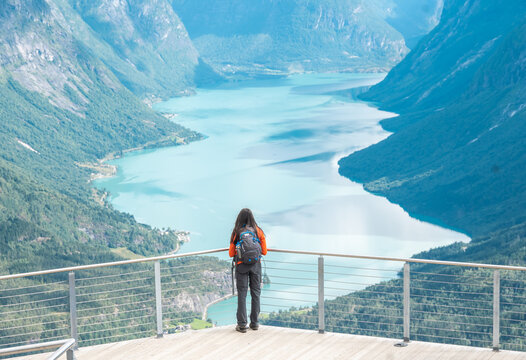 person on the top of the mountain in Loen Norway