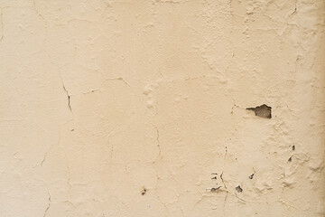 Yellow wall texture with dampness in the paint. Background wallpaper.