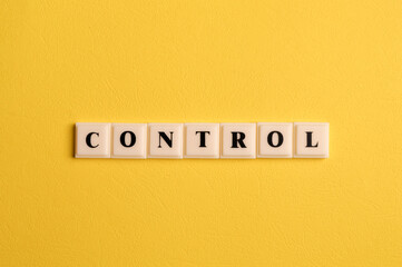 Square letters with text CONTROL isolated on yellow background