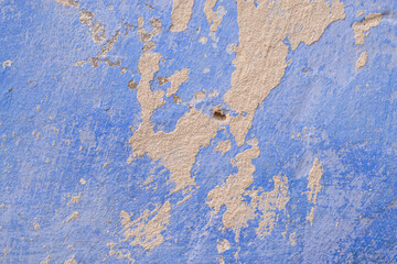 Texture of an old plastered wall, whitewashed in blue. Close-up, wallpaper, background.