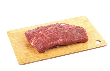 Piece of fresh, raw beef on a cutting board isolated on a white background.
