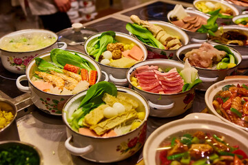 Assorted Chinese food set. Chinese noodles, fried rice, dumplings, peking duck, dim sum, spring rolls. Famous Chinese cuisine dishes on table. Top view. Chinese restaurant concept. Asian style banquet