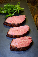 Sous-vide steak cut into pieces, cooked to eat beef on the stone table