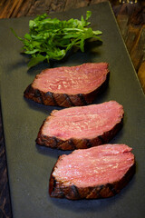 Sous-vide steak cut into pieces, cooked to eat beef on the stone table