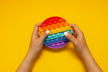 Colorful antistress toy fidget push pop it in kid's hands