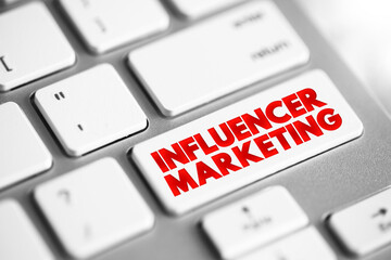 Influencer Marketing text button on keyboard, concept background.
