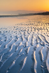 Fototapeta premium sea coast line in sunrise with lines on the beach
