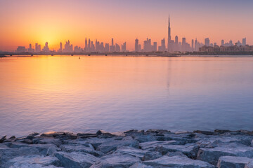 Fototapeta premium calm morning in bay with view to Dubai in sunrise with copy space