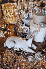 warm and cozy evening in Christmas room interior design,Xmas tree decorated by lights presents gifts,toys, deer,candles, lanterns, garland lighting indoors fireplace.holiday living room.magic New year