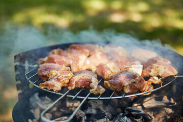 grilled pork skewers with smoke outdoors