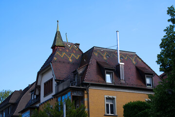 Fototapeta na wymiar Pitched roof with beautiful colored pattern on a sunny summer morning. Photo taken July 2nd, 2021, Zurich, Switzerland.