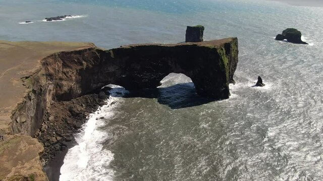 Lava arch at Dyrholaey peninsula next to Reynisfjara beach in Iceland
