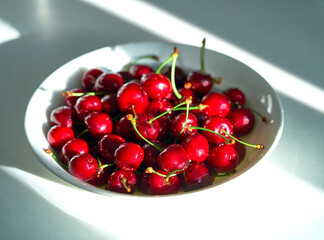 red cherry lies on a white background