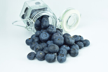 Fresh and beneficial small branch tomatoes, inside and outside the shopping cart. White background.