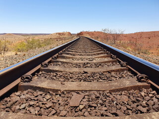 Empty head on view of railway track from ground leading into distance Western Australia.