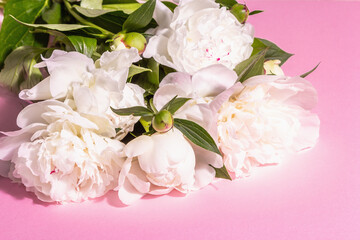 Bouquet of fresh white peonies on white old planks background