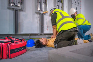 Electric worker suffered an electric shock accident unconscious. Safety team CPR for first aid Electric worker loses in electric shock accident at work on site. Accident in control room of factory.