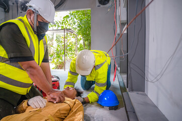 Electric worker suffered an electric shock accident unconscious. Safety team CPR for first aid...