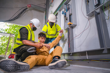 Electric worker suffered an electric shock accident unconscious. Safety team CPR for first aid Electric worker loses in electric shock accident at work on site. Accident in control room of factory.