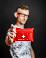 Unrecognizable person shows first aid kit closeup