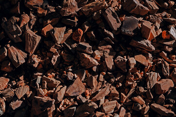 Top view on stones rocks spiky close up structure illuminated by the sun, texture for background
