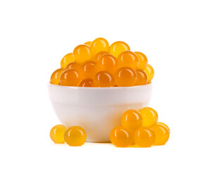 Yellow tapioca pearls for bubble tea isolated on white background. Tapioca pearls in white ceramic...