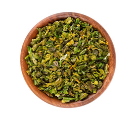 Dried green paprika flakes with seeds in wooden bowl, isolated on white background. Chopped jalapeno, habanero or chilli pepper. Spices and herbs. Top view.