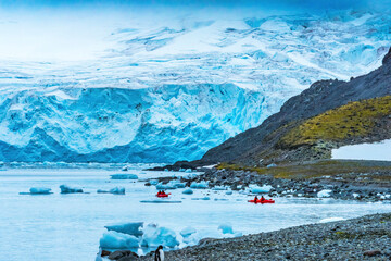 Blue glaciers red Kayaks Yankee Harbor Greenwich Island Antarctica.