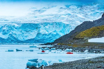 Fotobehang Blue glaciers red Kayaks Yankee Harbor Greenwich Island Antarctica. © Danita Delimont