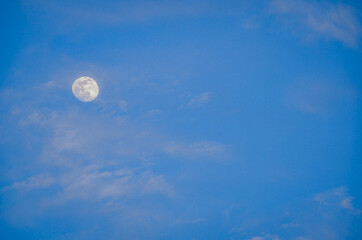the moon in the clear blue of the sky