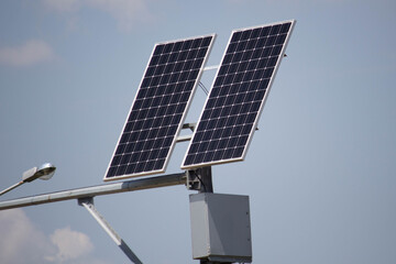 Obraz premium Two solar panels stand on a pipe, green energy 
