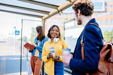 Language barrier concept. Handsome man offering coffee to an attractive positive african american...