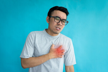 portrait of man having heart attack isolated on blue background
