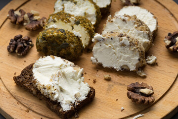 soft cheese on a cutting board and bread on which it is applied, healthy food made at home