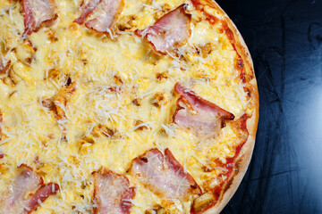 Chicken breasts with creamy sauce and grated cheese on a pizza. tasty fresh pizza on a thick crust with meat