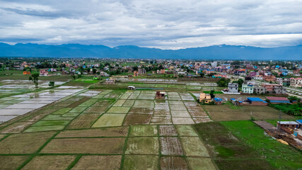 Aerial view of fresh cultivated land. Farmlands divided into rectangular block aerial shot. Monsoon season in Nepal.