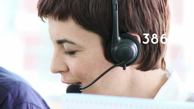 Animation of numbers changing over businesswoman using phone headset