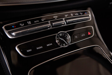 Luxury car interior details. Middle console with air and multimedia controls