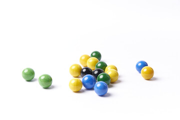 Colorful marbles balls, also called canicas isolated on white background. Childhood multicolored spheres.