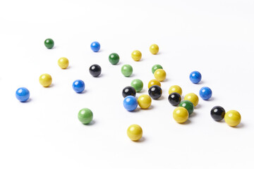 Colorful marbles balls, also called canicas isolated on white background. Childhood multicolored spheres.